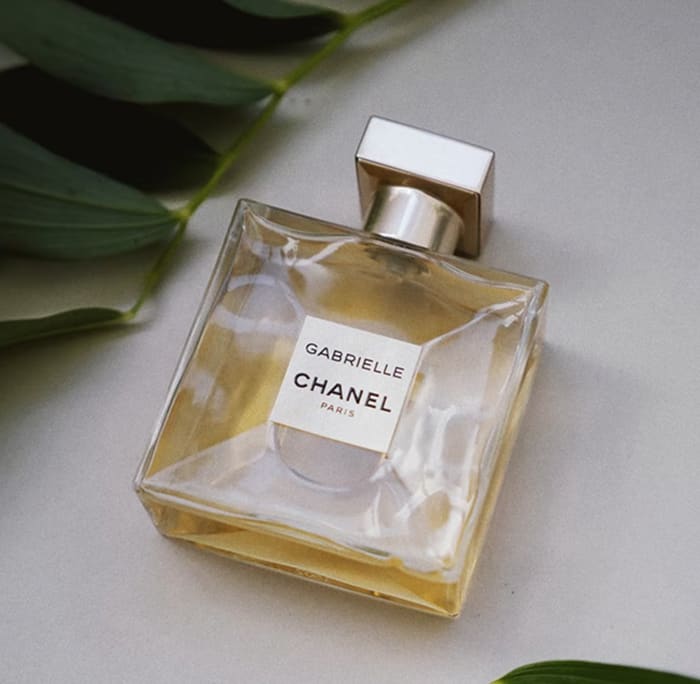 Gabrielle Essence Eau De Parfum bottle with green leaves